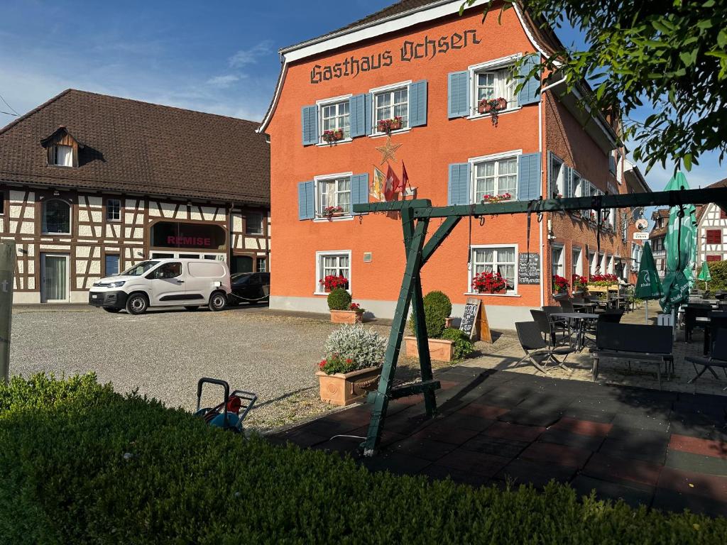 a building with a playground in front of a building at Gasthaus Ochsen in Tägerwilen