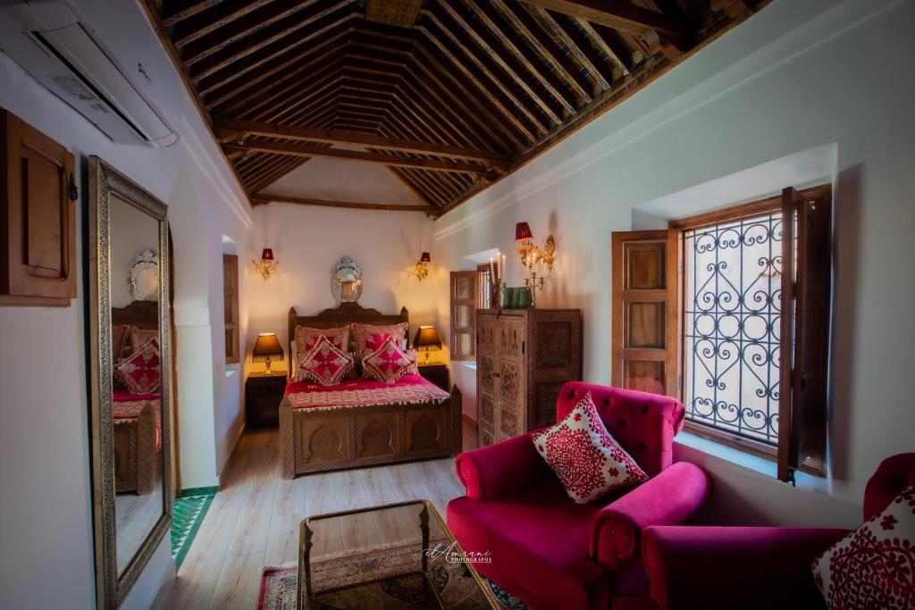 a living room with a bed and a window at Riad el Fenna 1974 in Chefchaouen