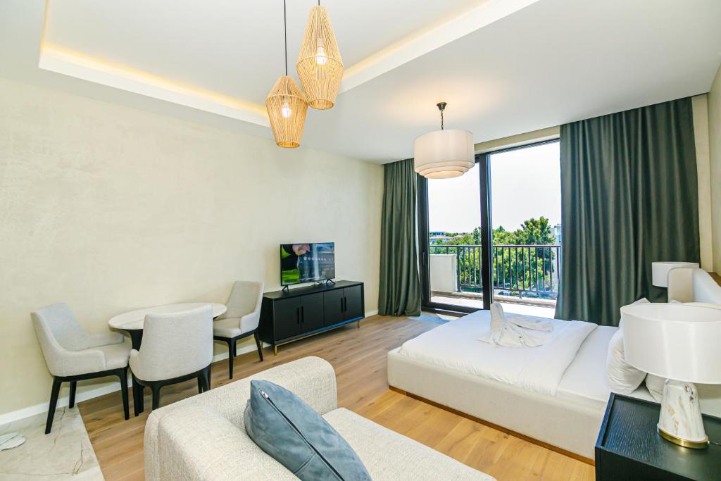 a hotel room with a bed and a table and chairs at FS The Grand Sea Breeze in Baku