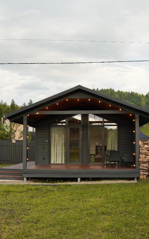 a house with a wrap around porch at Runa House in Verkhovyna