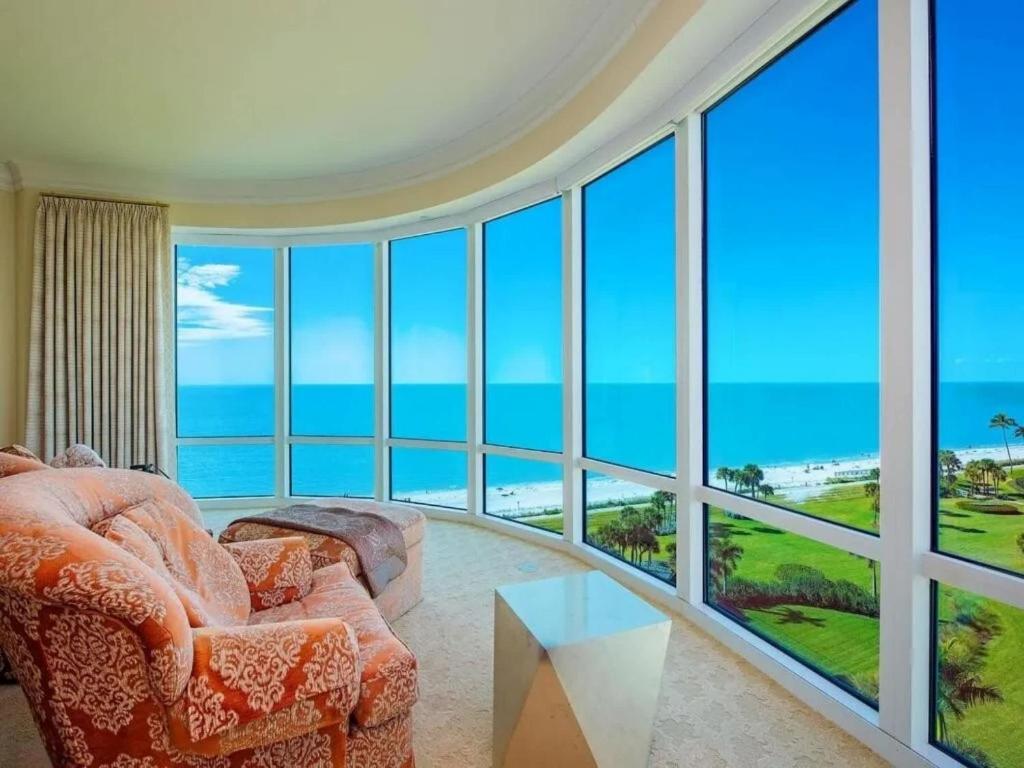 a living room with a view of the ocean at Beachfront Elegance Escape in Naples