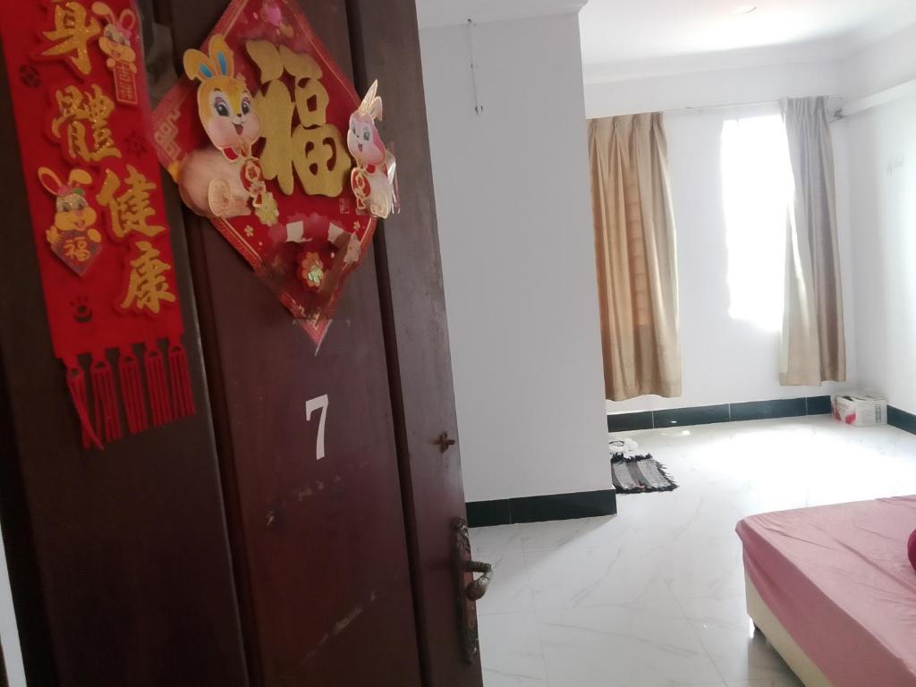 a room with a door with a sign on it at Sihanuk in Sihanoukville