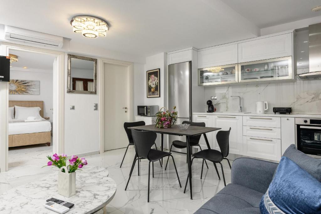 a kitchen and living room with a table and chairs at Villa Andriana in Panagia