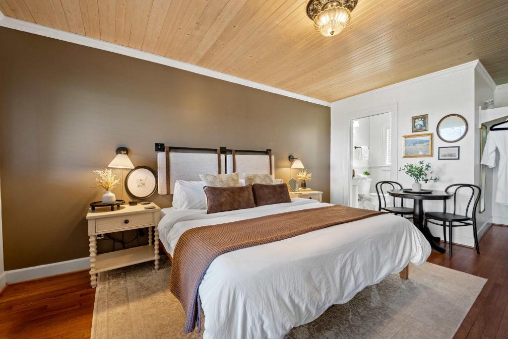 a bedroom with a large bed and a table at Historic Riverview Inn Seven in Chattanooga