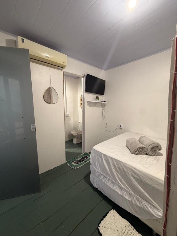 a bedroom with a bed and a flat screen tv at casa sol in Bragança