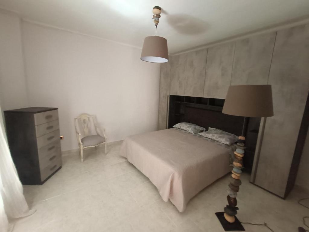 a bedroom with a bed and a lamp and a dresser at La terrazza sul fiume in Spoleto
