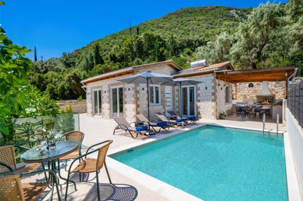 a villa with a swimming pool and a patio at Villa Mario by Villa Plus in Katokhórion