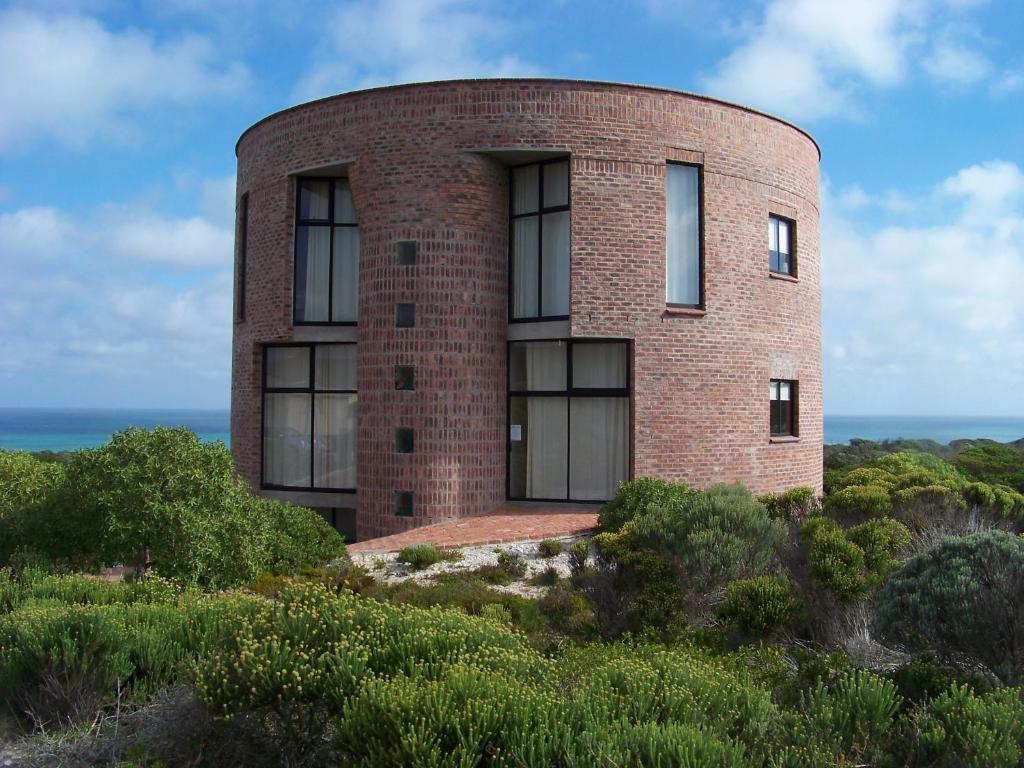 a brick building on top of a hill at Casa Dos Milagres Holiday Home in Agulhas