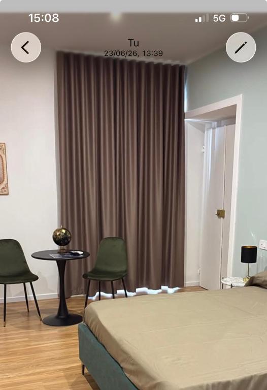 a bedroom with a bed and two chairs and a table at Sanleucio SILK ROOM in Caserta