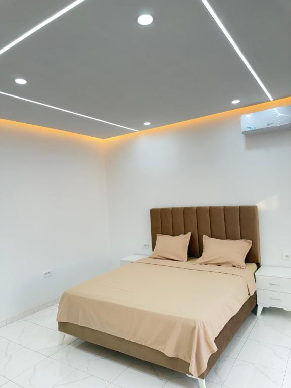 a bed in a white room with aolean at Villa VIP in Midoun