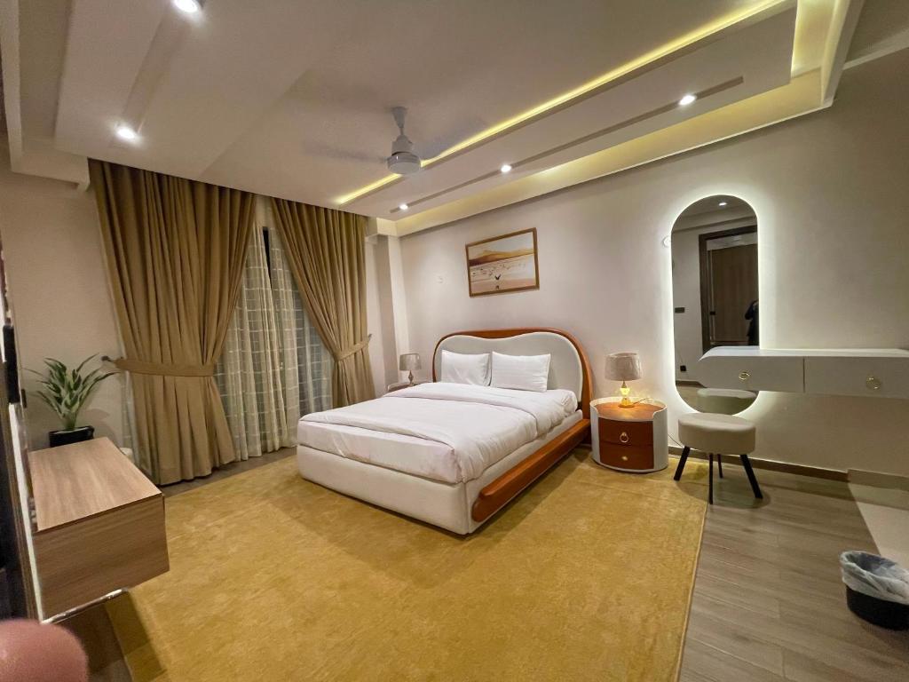 a hotel room with a bed and a sink at Designer Boutique Hotel Serviced Apartments Bahria Town Islamabad & Rawalpindi - LMY in Rawalpindi