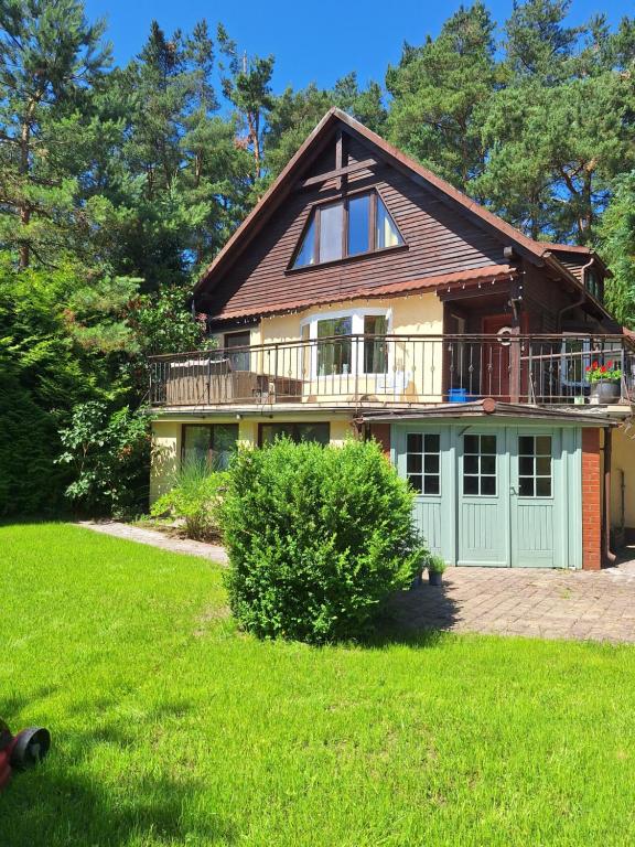 a large house with a balcony and a large yard at Przystanek Kaszuby in Kamień