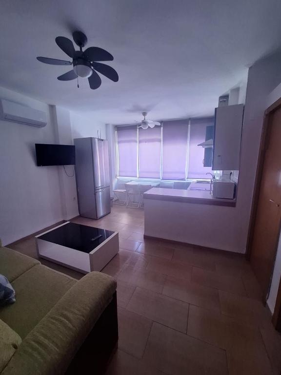 a kitchen with a couch and a ceiling fan at torremolinos centro parking privado in Torremolinos