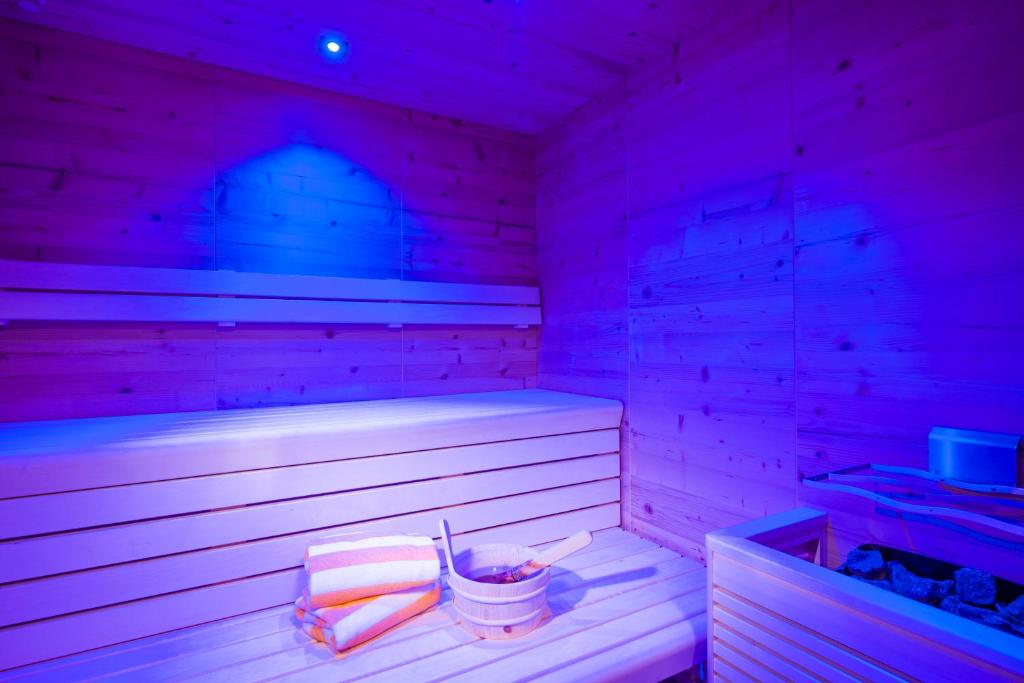 a sauna with purple lights in a room at Postresidenz in Mayrhofen
