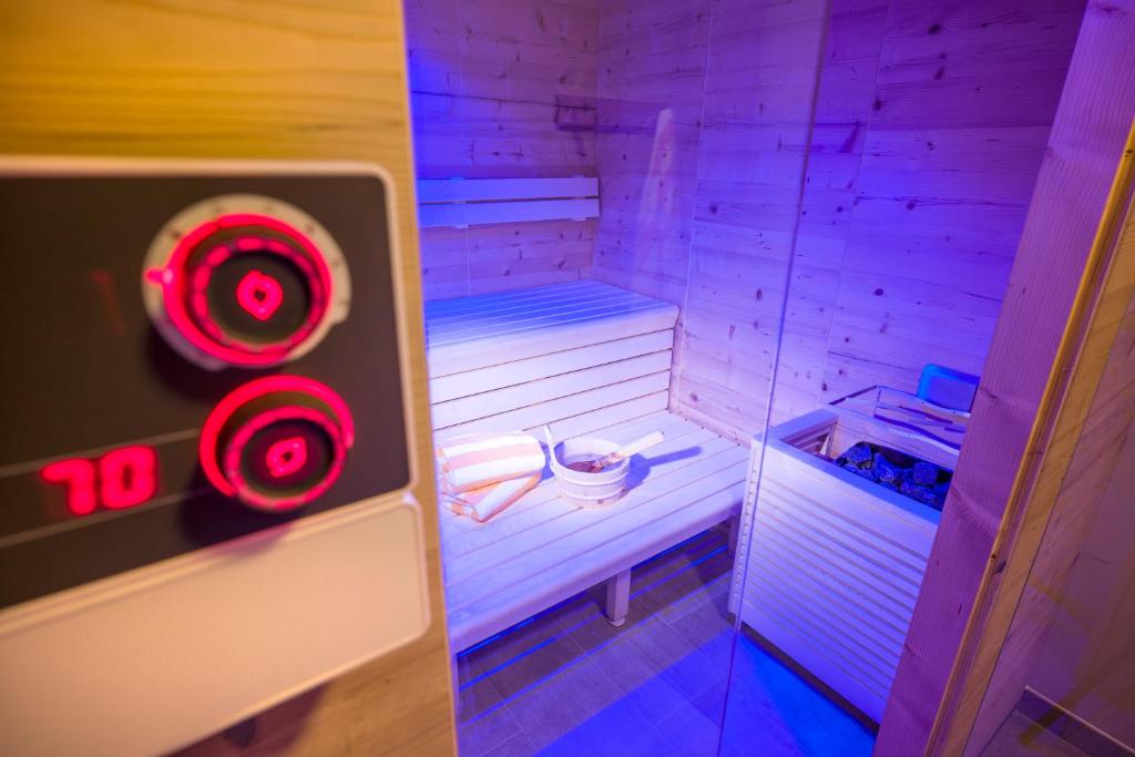 a small sauna with purple lights in a room at Postresidenz in Mayrhofen