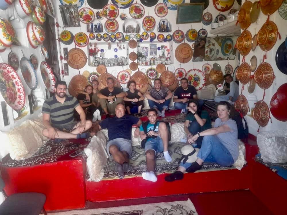 a group of people sitting on a couch in a room at Cultural guest house in Hārer