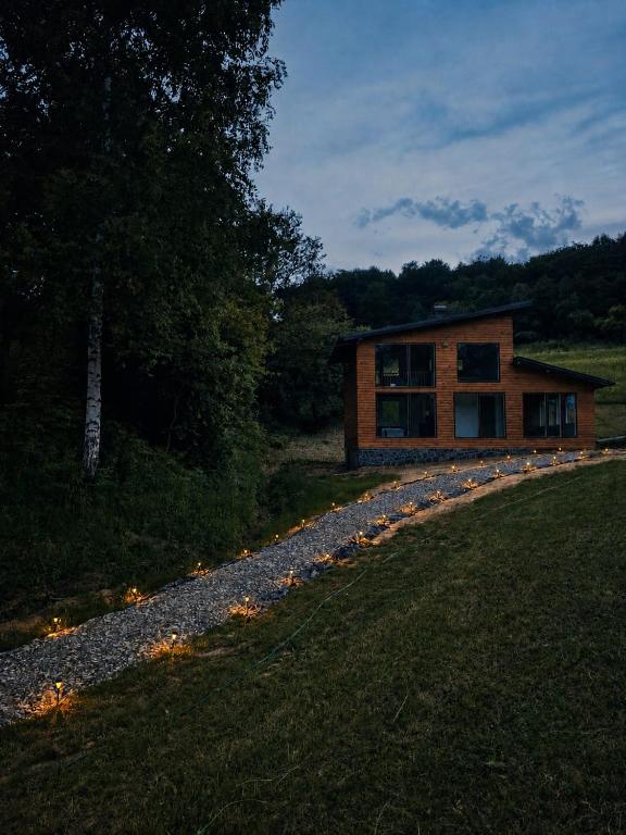 a house on a gravel road next to a field at Kućica Sreće in Visoko
