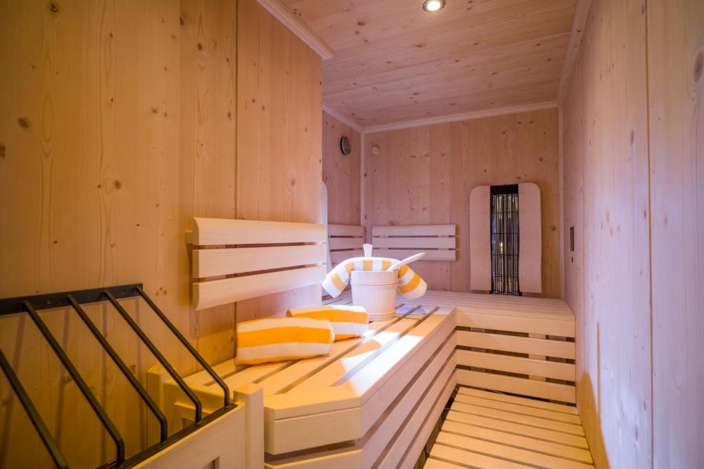 a sauna with two beds in a wooden room at Postresidenz in Mayrhofen