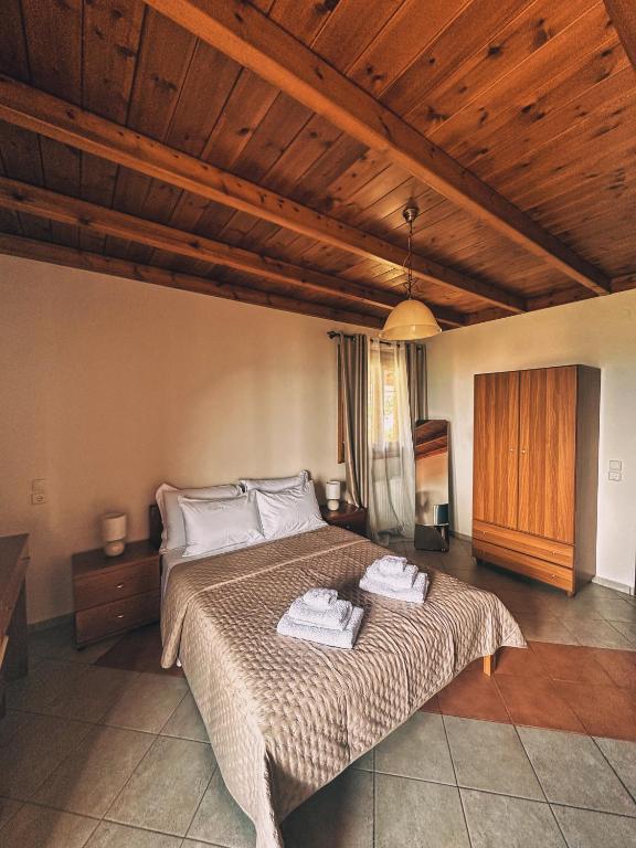 a bedroom with a bed with two towels on it at The Stone Alley in Konitsa