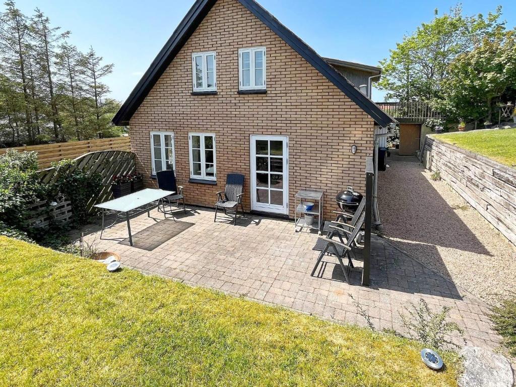 a brick house with a picnic table and a grill at 4 person holiday home in Hanstholm-By Traum in Hanstholm