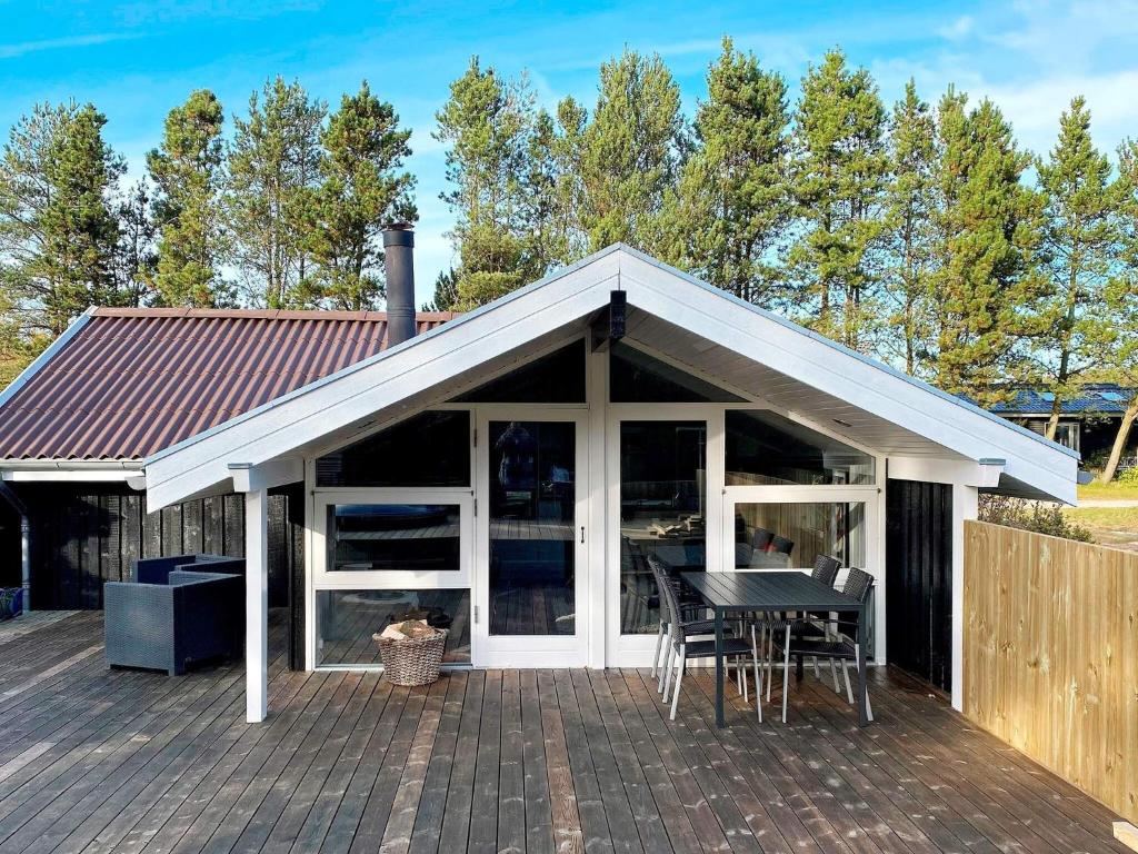 a pavilion with a table and chairs on a deck at 6 person holiday home in Brovst in Brovst