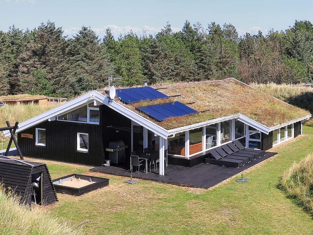 a house with a roof with solar panels on it at 14 person holiday home in Blokhus-By Traum in Blokhus