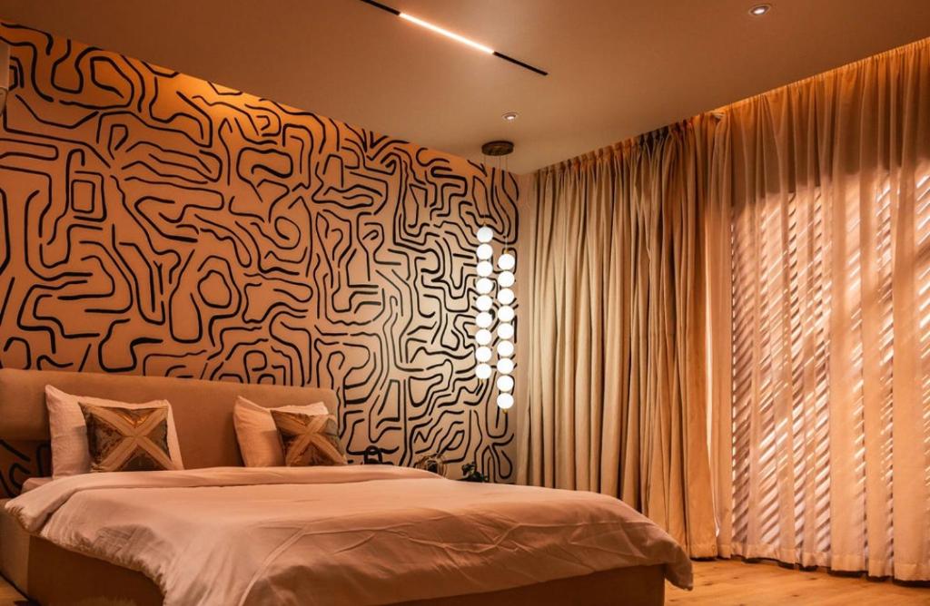 a bedroom with a bed and a wall with a pattern at 4 Bedroom duplex in Orchid in Lekki