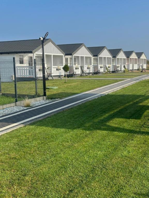 a road in a park with a row of houses at Baltic Holidays in Gąski