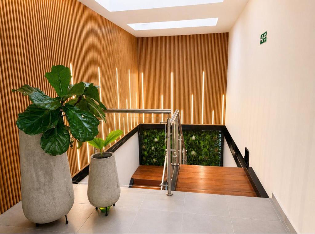 a staircase with two potted plants in a building at GRAND HOTEL JAMUNDI in Jamundí