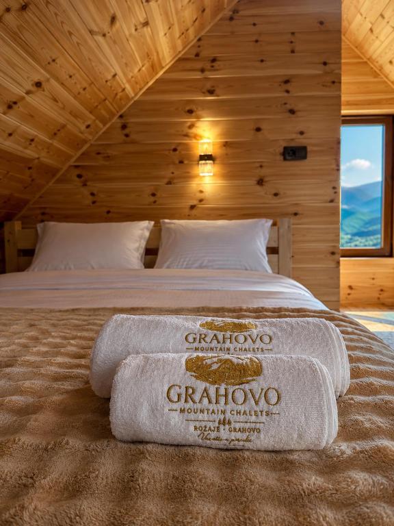 a bedroom with a bed with towels on it at Grahovo Mountain Chalet in Grahovo