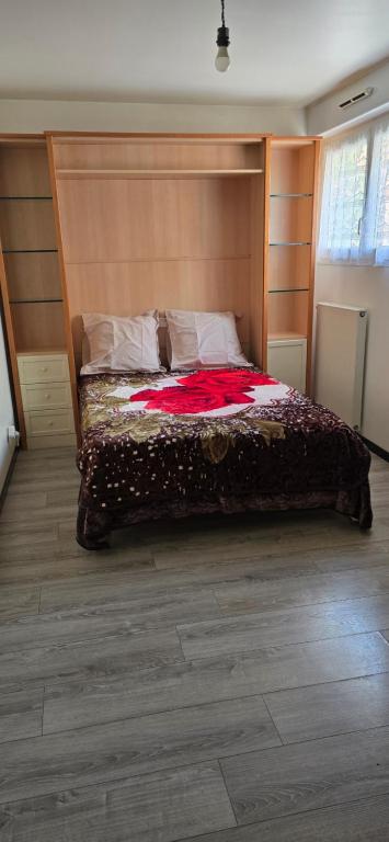 a bedroom with a large bed with a wooden headboard at 10 mn Paris in Gennevilliers
