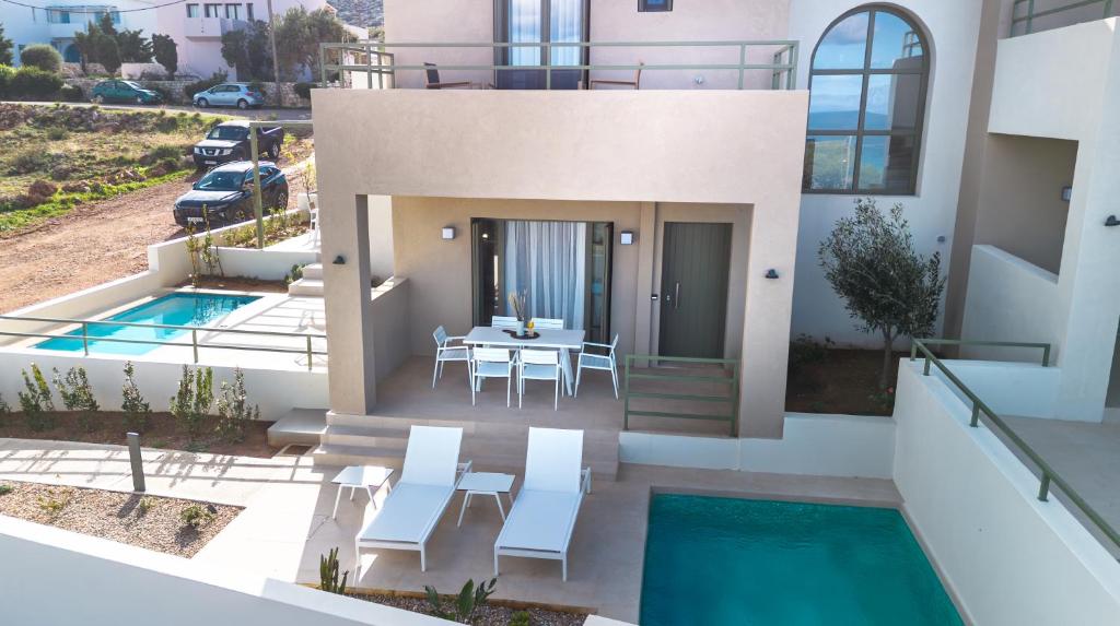 a house with a pool and a table and chairs at Villa Artemis 2 - Etheras Properties in Kythira