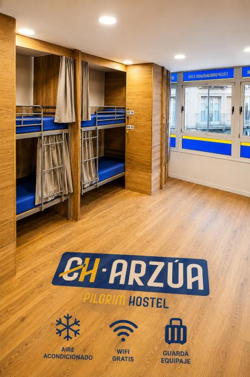 a room with bunk beds in a prison house at CH Arzúa Pilgrim Hostel in Arzúa