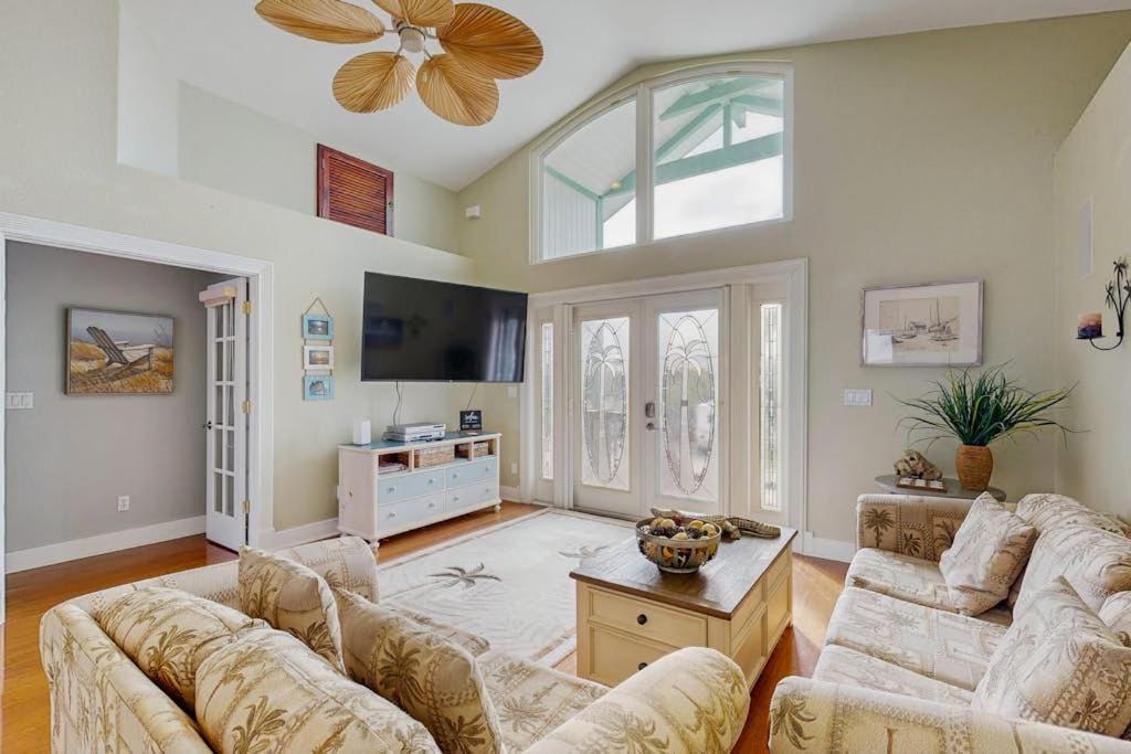 a living room with two couches and a tv at Diversity in Saint James City