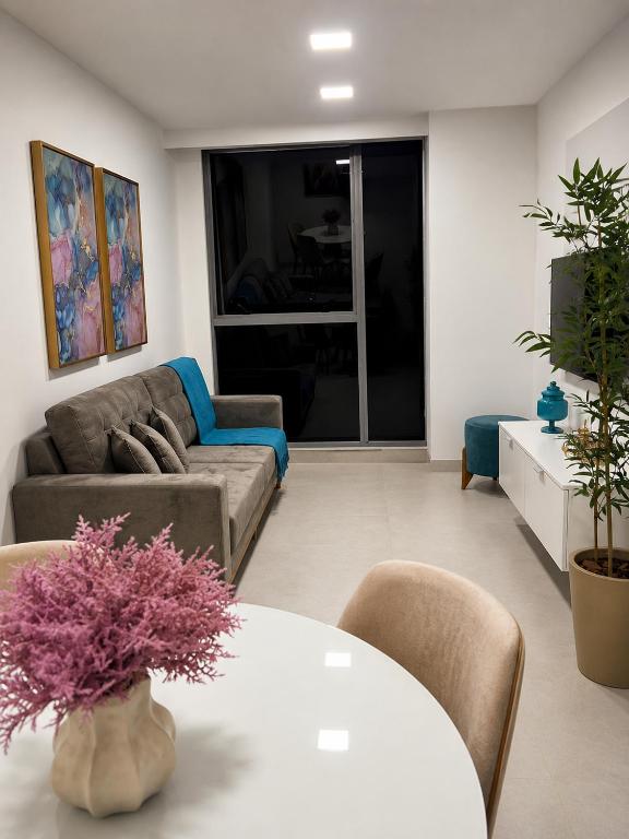 a living room with a couch and a table at Life Center in Caruaru