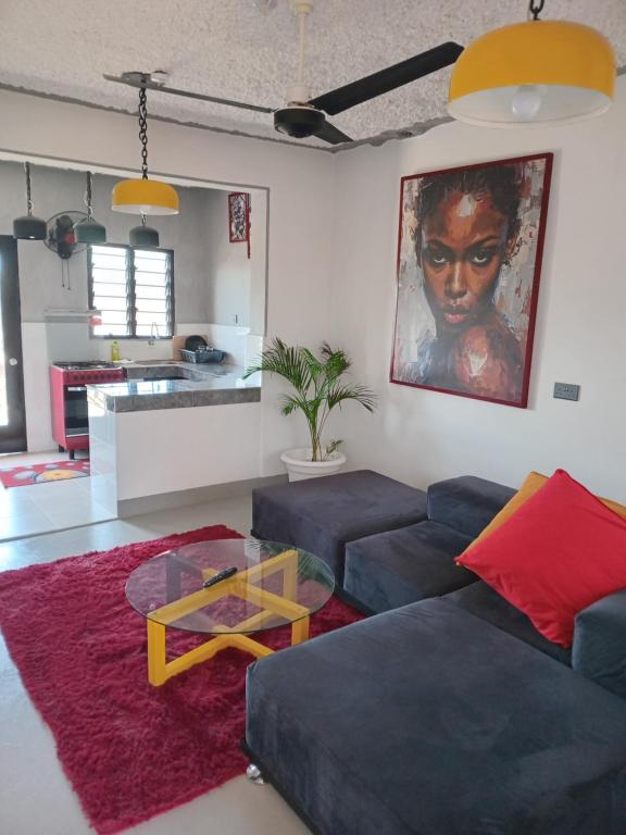 a living room with a couch and a table at TN Apartments deviat in Diani Beach