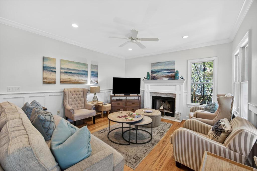 a living room with a couch and a fireplace at OG14: 14 Ocean Green in Kiawah Island