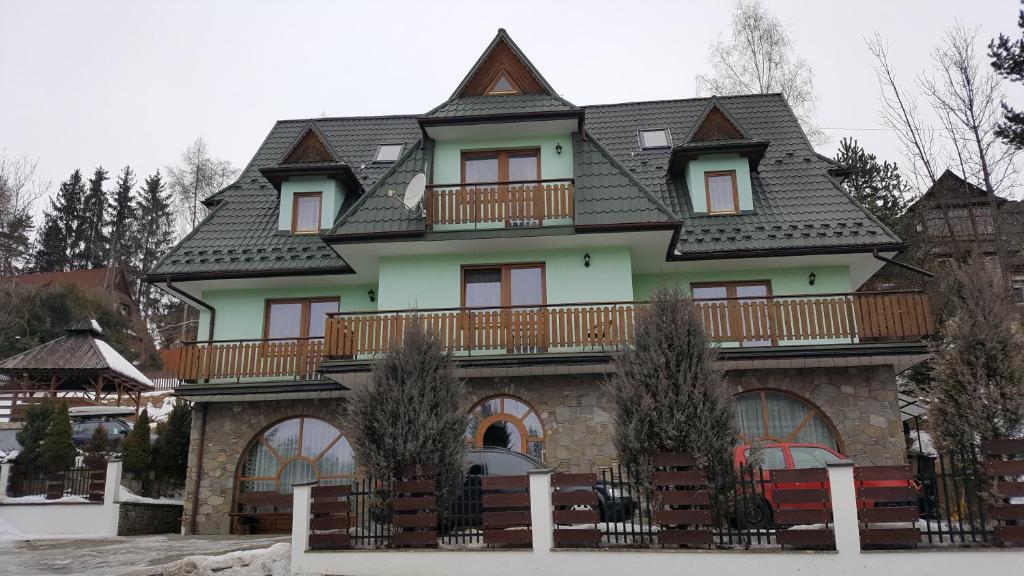 a large house with a balcony on top of it at Willa u Tomali in Bukowina Tatrzańska