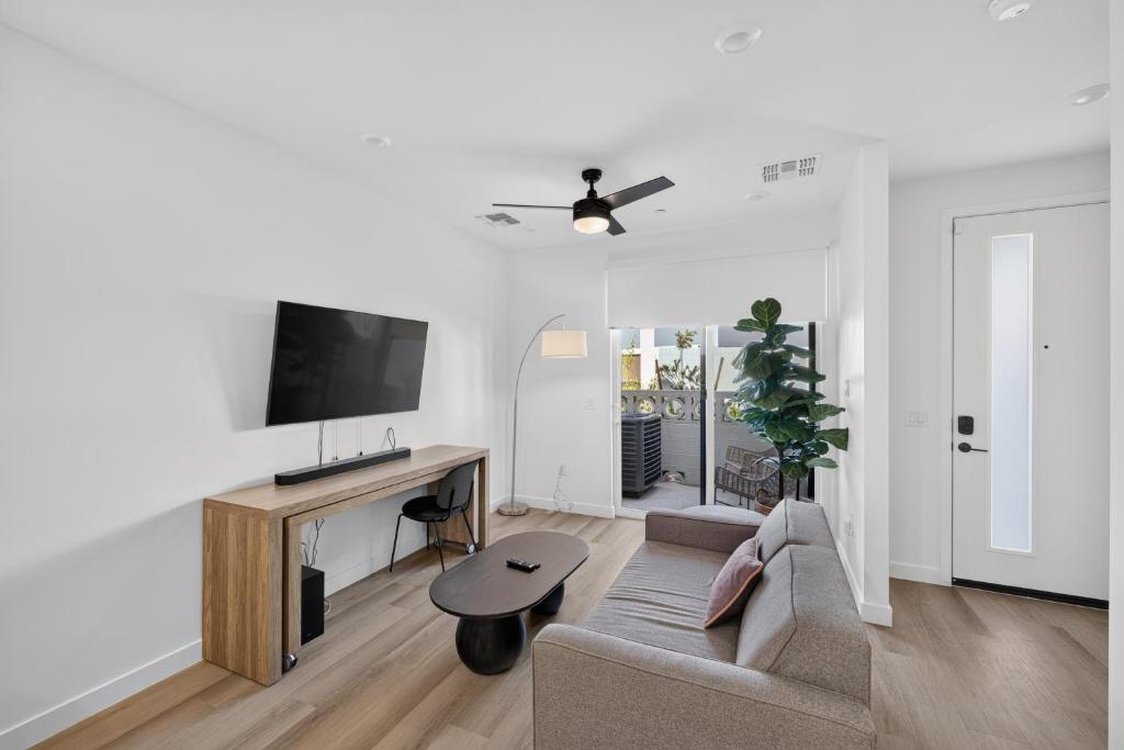 a living room with a couch and a tv at Sonoran Oasis with Pool, Spa & BBQ Area in Phoenix