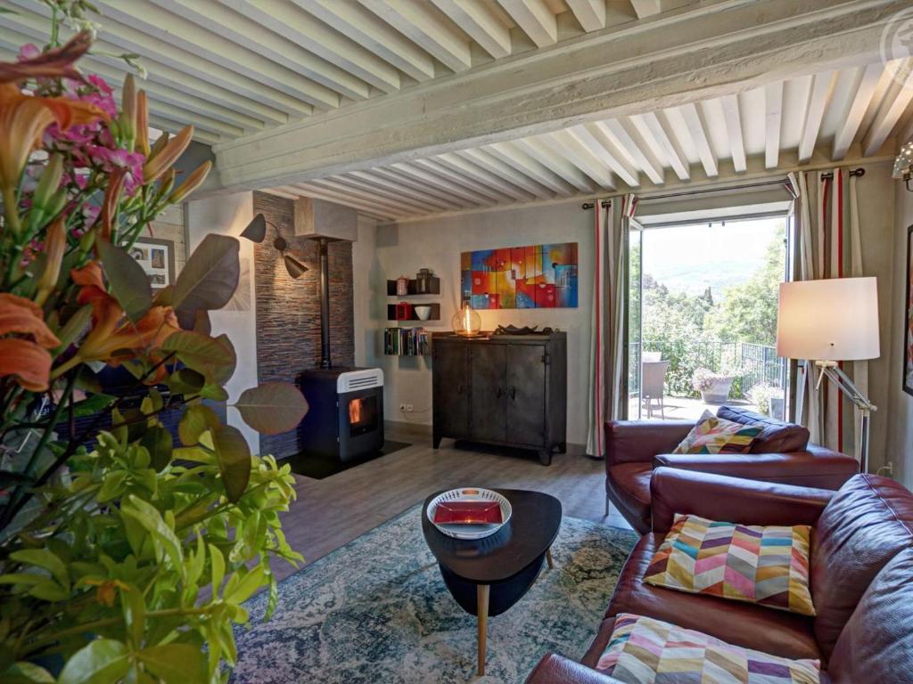 a living room with a couch and a table at Gîte au cœur d'un village médiéval, charme et confort moderne - FR-1-496-125 in Chagnon