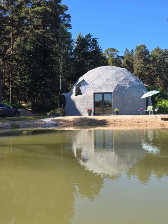 a dome house is reflected in a body of water at Mullimaja in Treimani