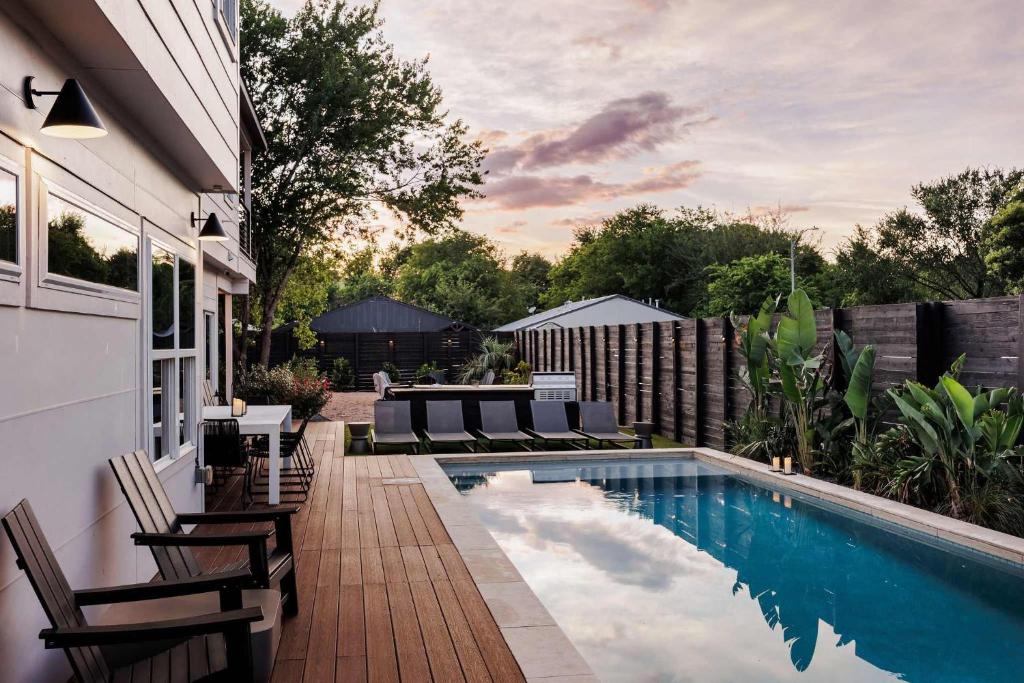 a patio with chairs and a swimming pool at Modern Designer Home with Shared Pool in Austin