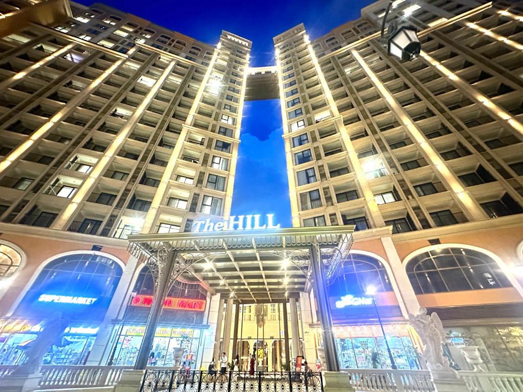 a view of two tall buildings at night at Diamond Suite The Hill Phu Quoc in Phú Quốc
