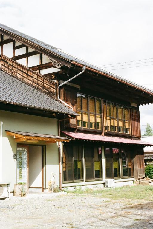 a large building with a lot of windows at ましこのま- 明治の建物をリノベした街中ローカルステイ in Mashiko