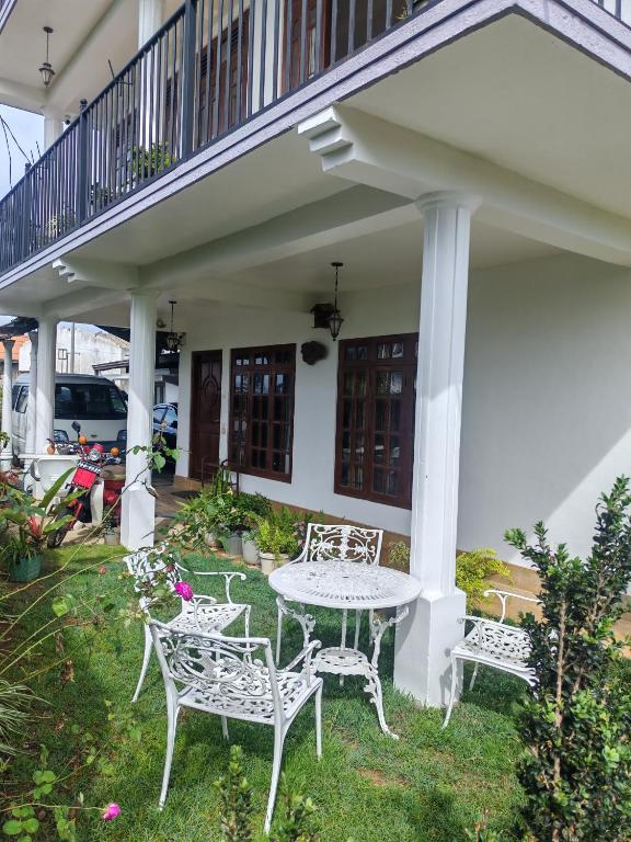 a white table and chairs sitting on a patio at AGP home in Nuwara Eliya