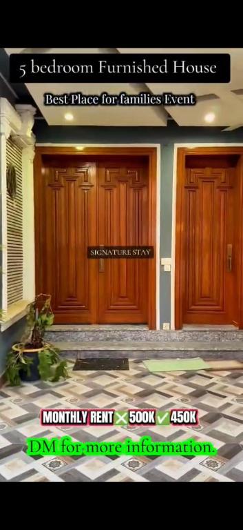 a front door of a house with a sign on it at Behria town phase 8 in Rawalpindi