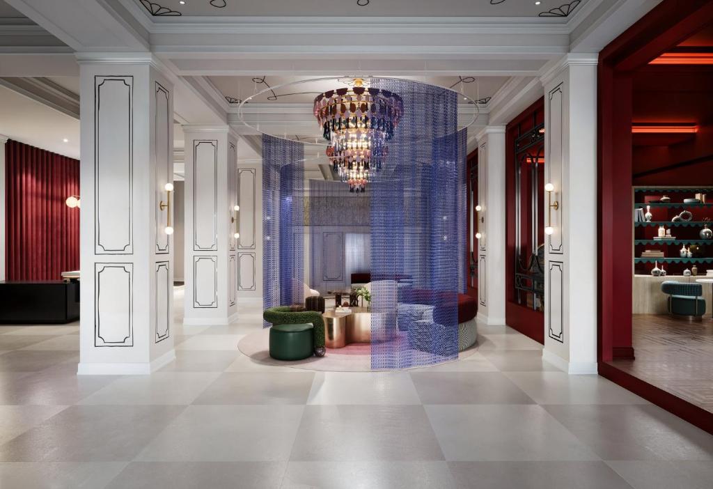 a lobby with a chandelier and blue tiles at Hotel Indigo Dallas Downtown by IHG in Dallas