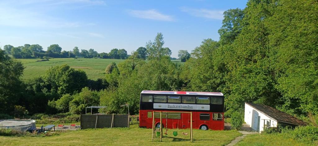 a red double decker bus parked in a field at insolite bus anglais le Buckinghambus in Saint-Philbert-sur-Risle