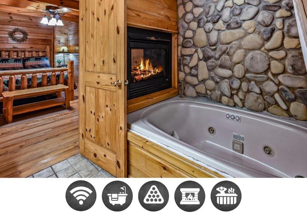 a bathroom with a tub and a fireplace at Mountain Joy cabin in Gatlinburg
