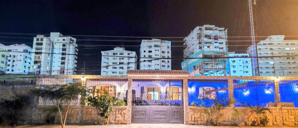a building with lights in front of a city at night at Casa Niño Peregrino Salinas in Salinas